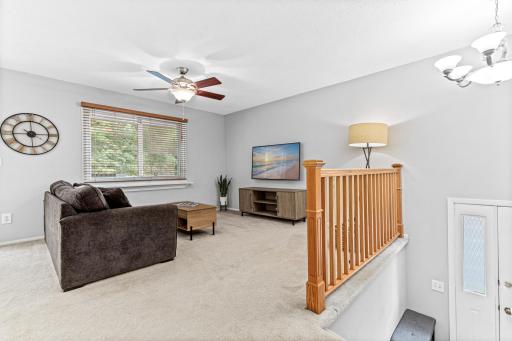 Living room with solid wood railing and ceiling fans