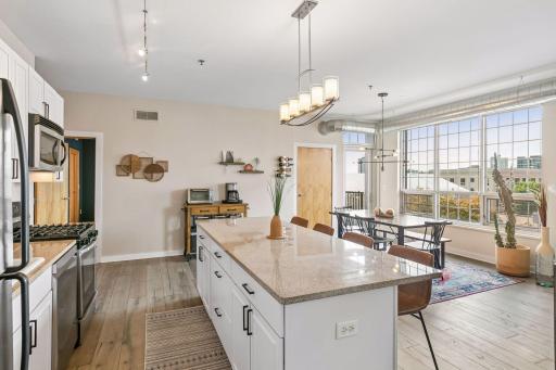 Well-appointed dining area surrounded by expansive windows that provide excellent natural light and views of the surrounding Minneapolis skyline.
