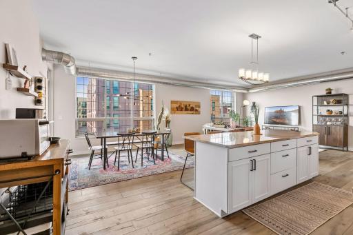 Spacious open-concept living area combines a contemporary kitchen, dining space, and comfortable living room into one cohesive gathering space.