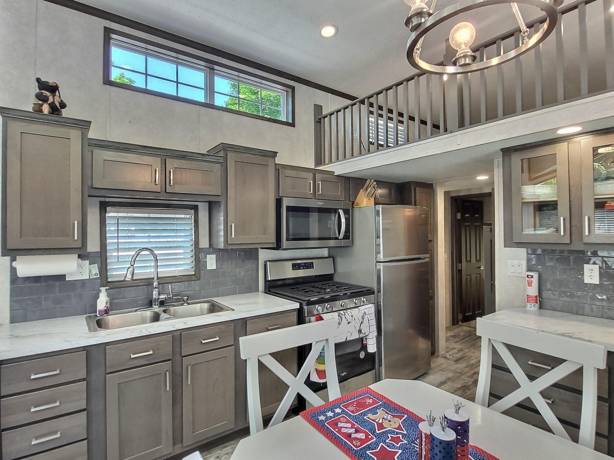 Fresh modern kitchen and gas fireplace just off the end of the counter to keep it warm on chilly days.