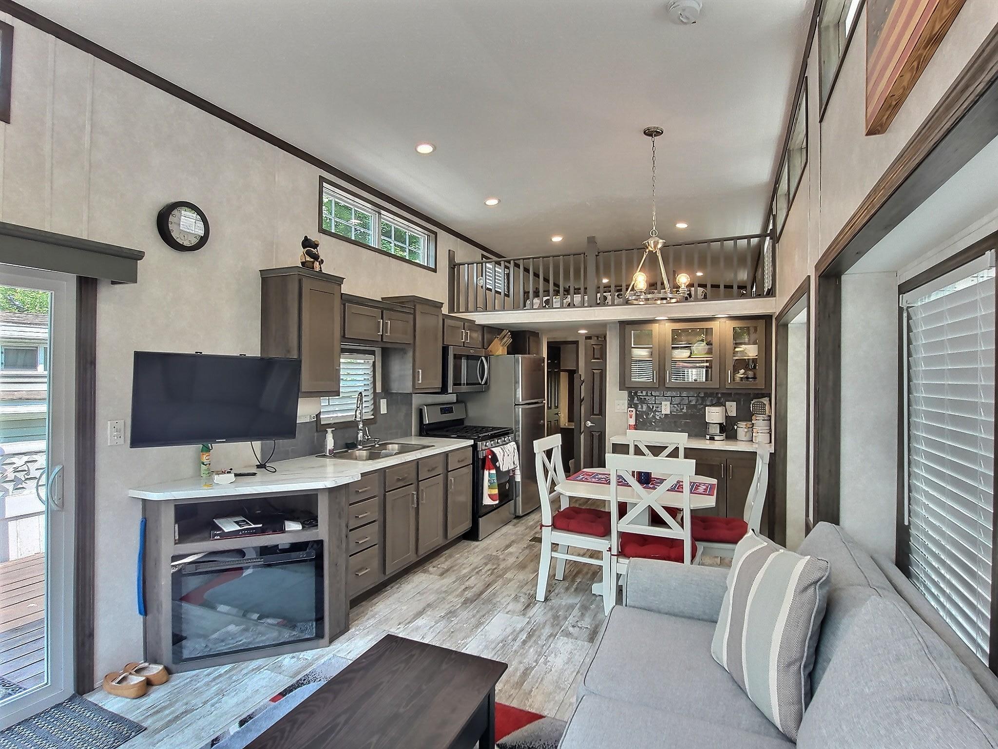 Easy cleaning with vinyl plank flooring that runs throughout this area of the park model.