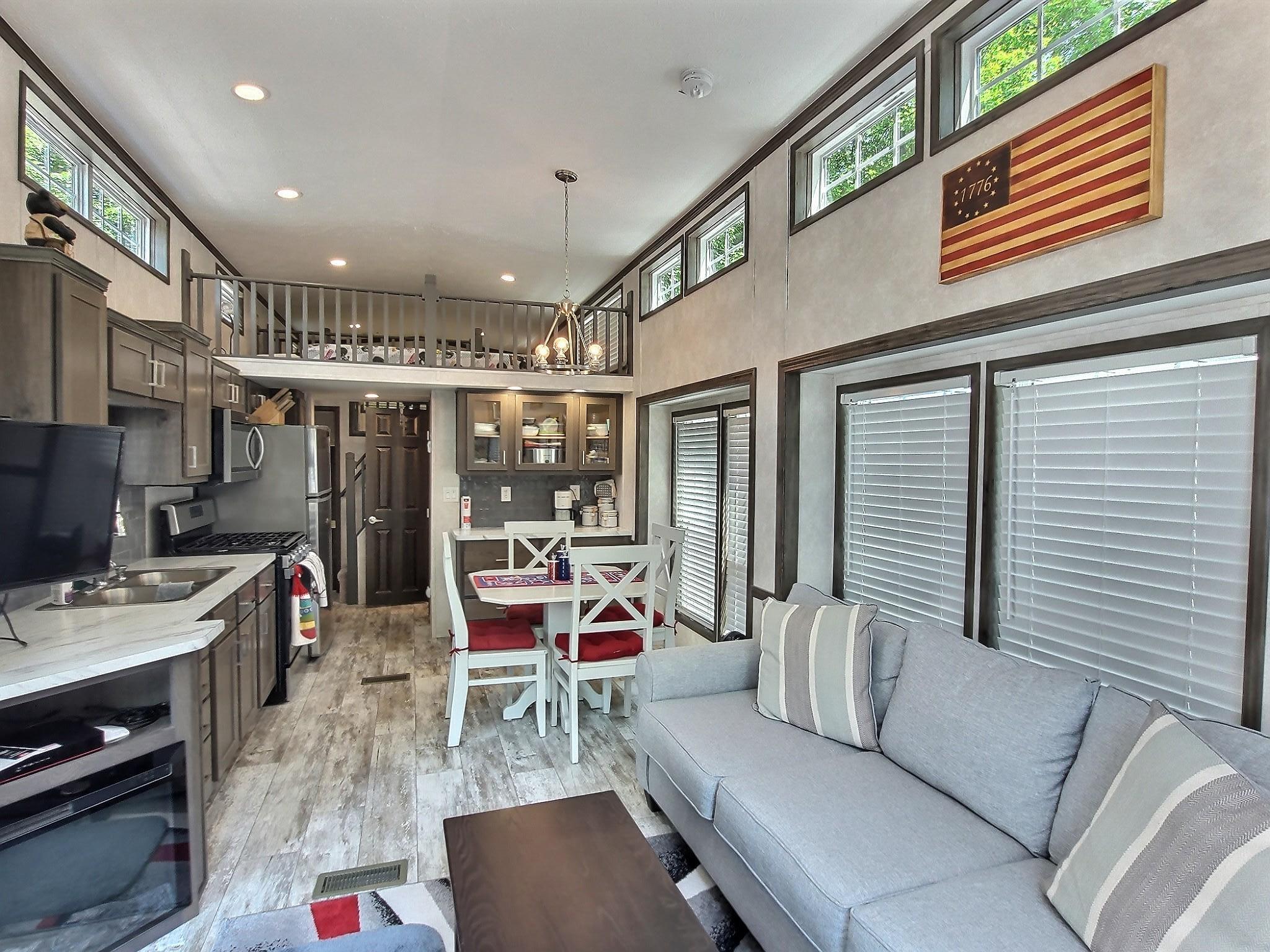 This 2023 Park Model offers low-maintenance, modern living with 1 bedroom, 1 full bath, and two spacious loft areas currently used as sleeping quarters.