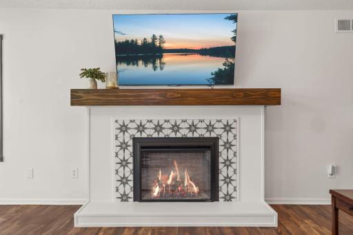 The fireplace in the main level living room is tiled and offers a modern look to the room.
