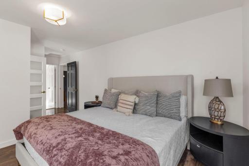 The main level primary suite is spacious and offers views of the backyard.