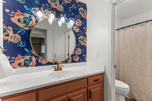 The upper level full bathroom has a door to separate the toilet and shower.