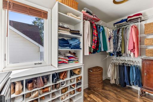 The walk-in closet in the primary suite has built in cabinetry for staying organized.
