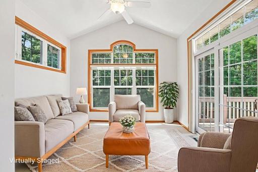 Light and bright Sunroom opens to a large deck with views of the woods. .jpeg
