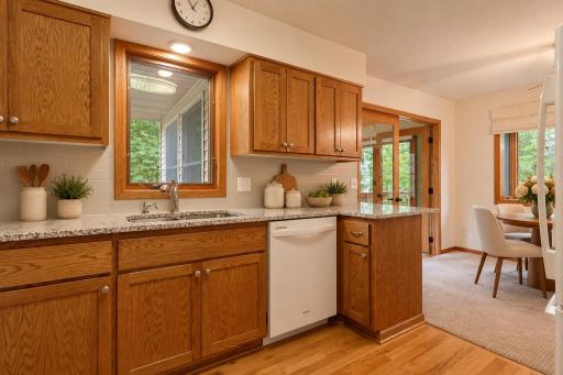 A window above the kitchen sink brings in views of the surrounding trees, with a reverse osmosis filtration system adding extra convenience. (Virtually staged photo.)