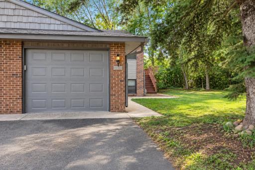 Located mid-cul-de-sac, the home includes an attached garage plus an additional asphalt parking pad for added parking convenience.