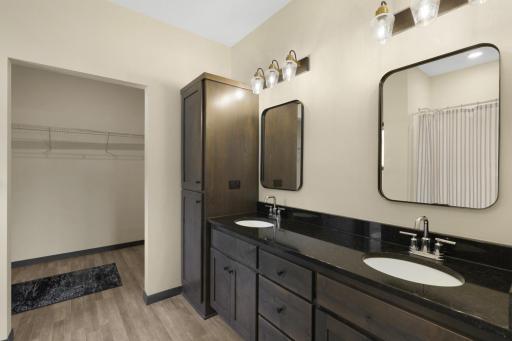 Primary bedroom with double sinks , great storage, and a large walk-in closet.
