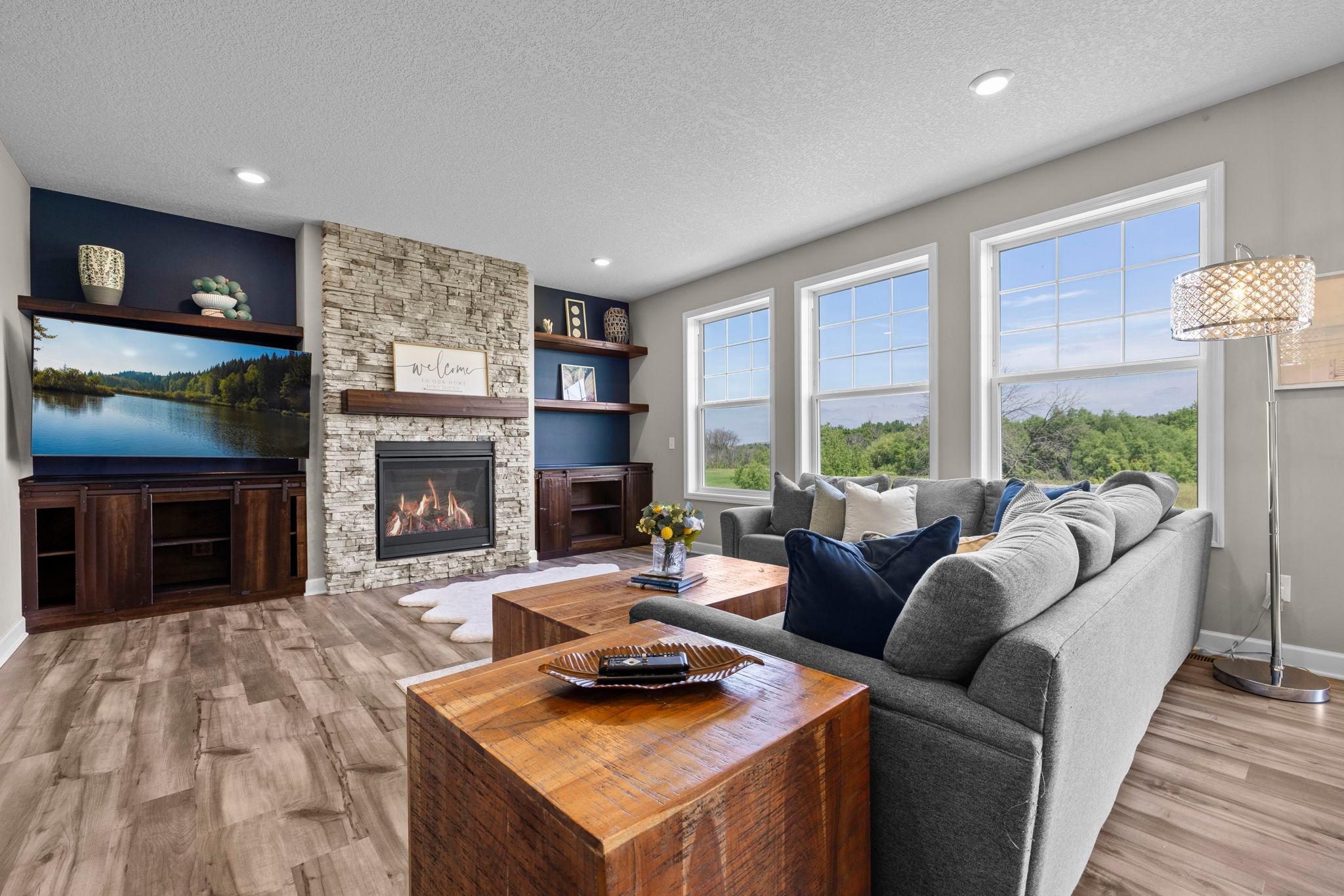 Gorgeous stone surround gas fireplace, wall of windows and the view are showstoppers!