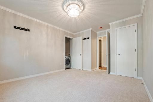 Bedroom with in closet washer/dryer.