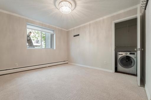 Bedroom with in closet washer/dryer.