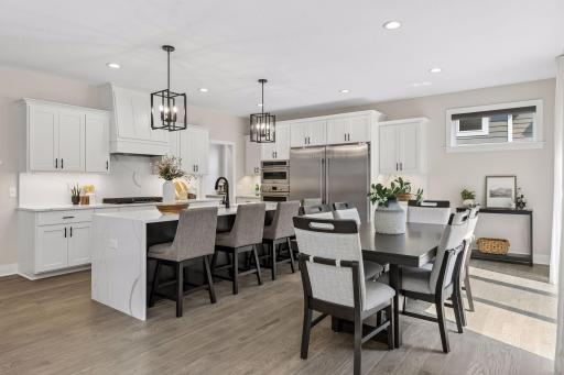 Oversized kitchen island with breakfast bar and eat-in kitchen