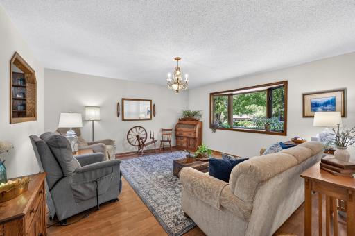 Inside, the bright and inviting living room features hardwood floors and a large picture window.