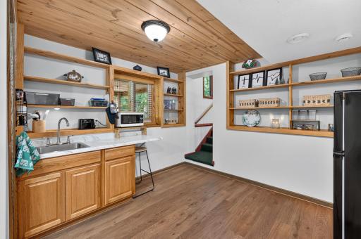 Renovated lower-level kitchenette creates added flexibility for generational living or extended guests.
