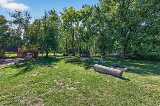 A backyard made for enjoying the outdoors with plenty of green space and room for recreation.