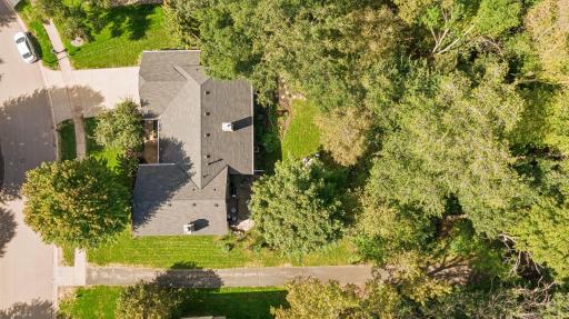 Aerial showing the lovely wooded setting and trail to the lake