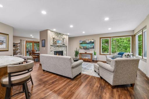 Spacious and sun-filled living room anchored by the gas FP and stone surround