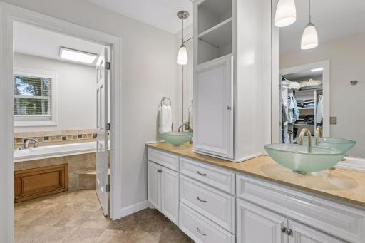 Primary Full Bath with double vanity and an abundance of storage