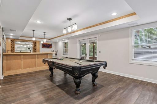 The game area, large screen, wet bar area and screened porch are an entertainers dream