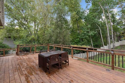 Large two level deck overlooks the private fully fenced backyard