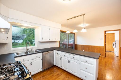 Freshly updated kitchen with enamel painted cabinets, new matte countertops, and subway tile backsplash