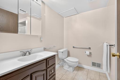 Lower level 3/4 bathroom with newer tile floors