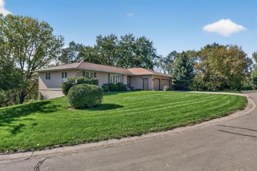 Expansive .5-acre corner lot offers a generous setting for this well-maintained 2,742 SF rambler, surrounded by mature trees and established landscaping.
