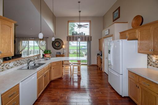 Hot water faucet, glass backsplash, hardwood floors