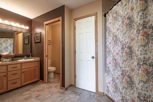 Upper-level bath also offers double sinks and a linen closet