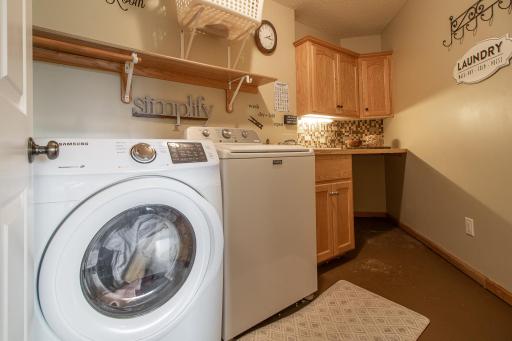 Dedicated laundry room with sink, cabinets & folding counter