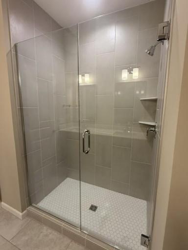 Elegant tilework and modern fixtures elevate the walk-in shower, offering a sleek, spa-inspired design that feels both timeless and on-trend.