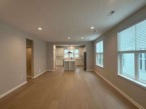 Open floorplan creates a seamless connection between the family room, kitchen, and dining areasâideal for entertaining and family togetherness.