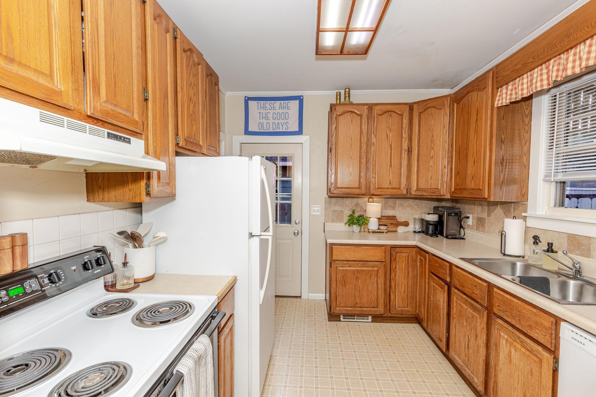 Kitchen w/ side door to fenced yard