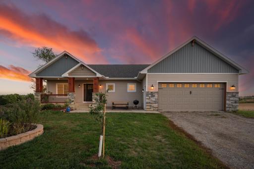 Front porch pillars wrapped in stone, Window accents in the garage door