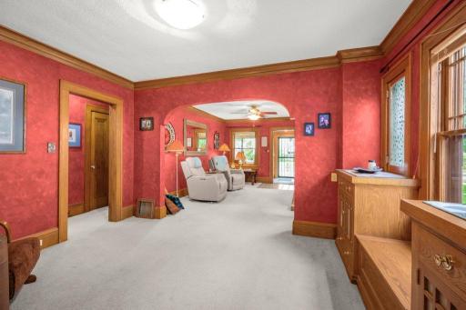 Another view of the living room from the other side showing the archway and the beautiful, original woodwork