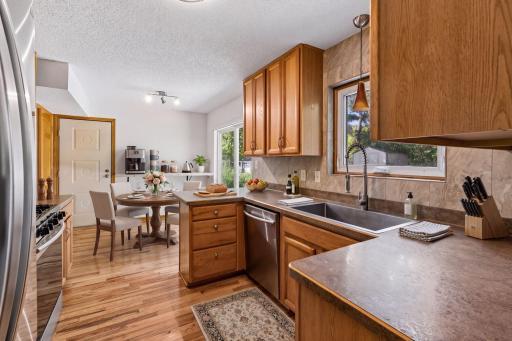 Virtually staged kitchen and breakfast area illustrate a possible dining setup