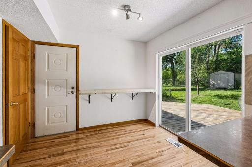 Breakfast area with a wall-mounted counter and views of the deck and yard.