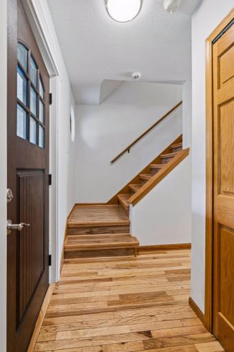 Hardwood stairs lead to the upper level, where all three bedrooms are located.