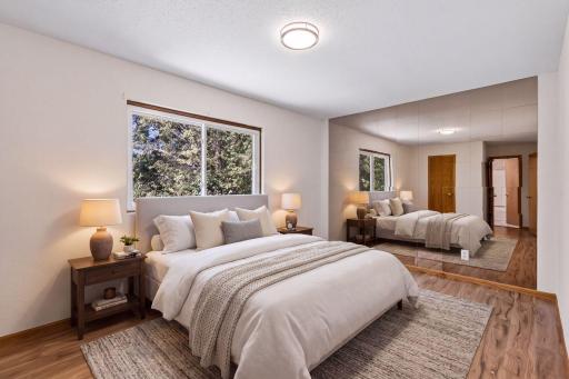 Virtually staged primary bedroom illustrates a possible furniture arrangement.
