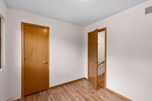 Alternate view of bedroom two, showing the closet and hallway access.