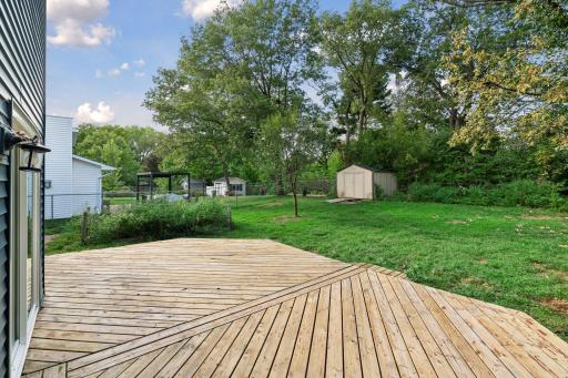 Deck and backyard offer space for outdoor dining, relaxing, and gardening.