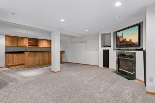 Lower level family room includes gas fireplace and bar.