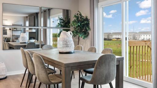 Bright dining area with backyard views and easy access to the outdoor patio. *Photo of similar home. Virtually staged.