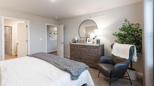 Spacious and inviting, this primary suite combines comfort, privacy, and natural light. *Photo of similar home. Virtually staged.