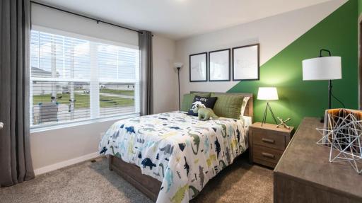 Main floor secondary bedroom #3. *Photo of similar home. Virtually staged.