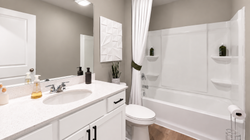 Main floor full bathroom. *Photo of similar home. Virtually staged.