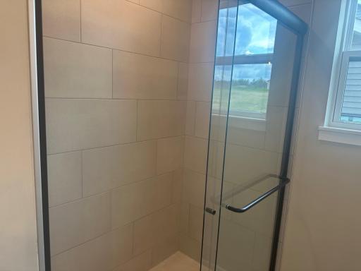 Tile shower in the primary bath as shown in 8852 63rd St. S.