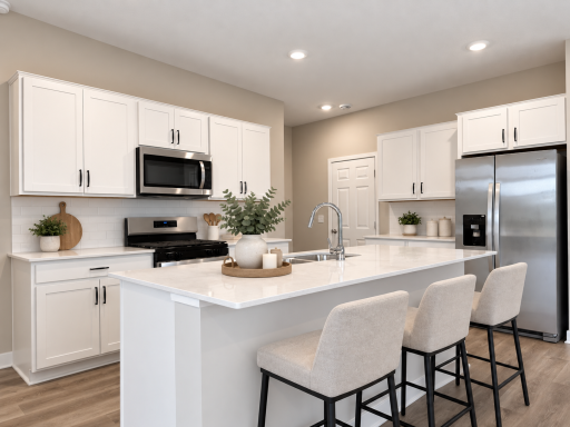 The spacious kitchen features an oversized island with seating for four, making it the perfect spot for morning coffee, meal prep and gathering. *Photo is of similar home. Virtually staged.